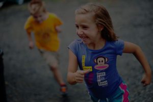 A girl wearing a yellow shirt.